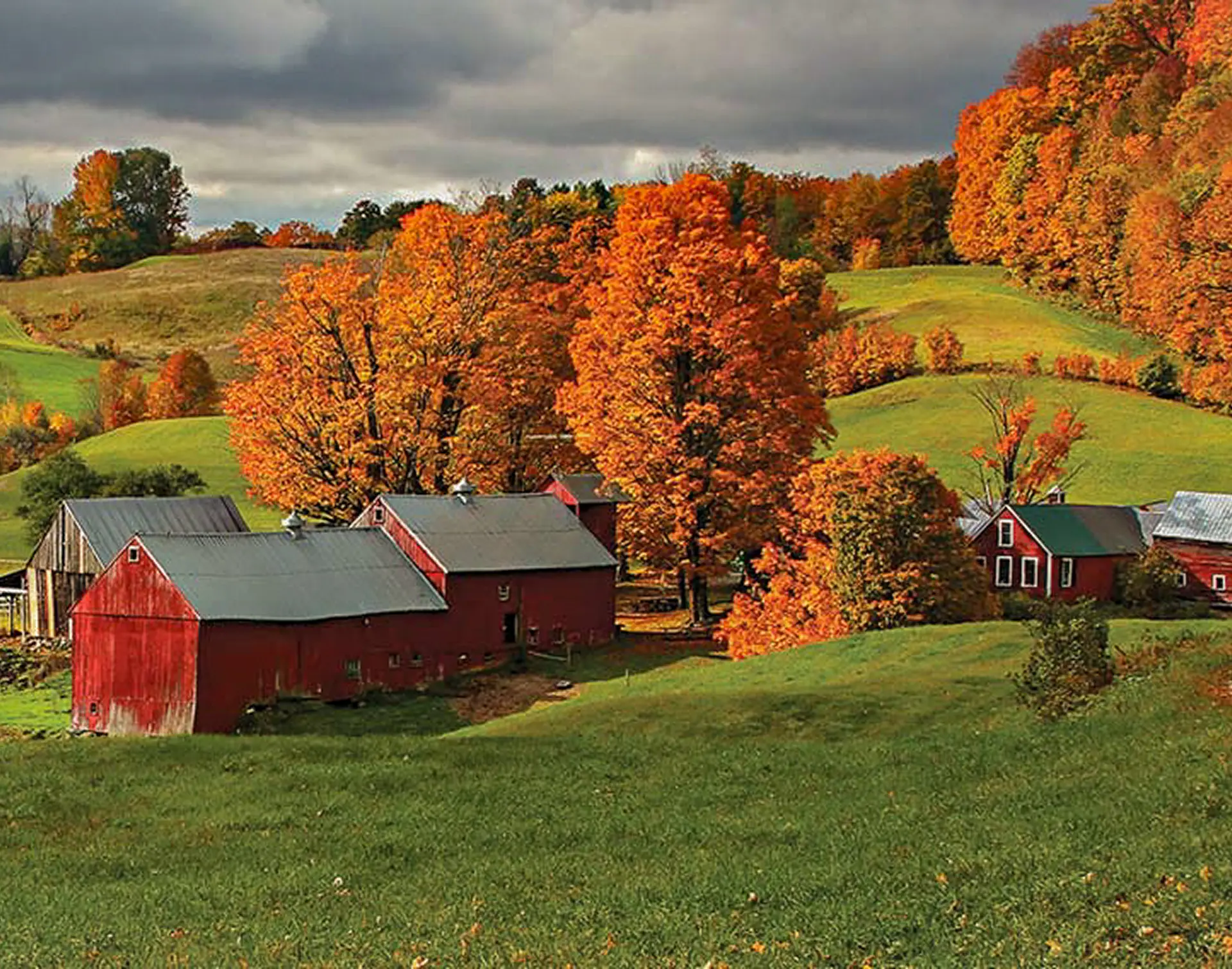 Vermont red barn and hills with fall foliage
