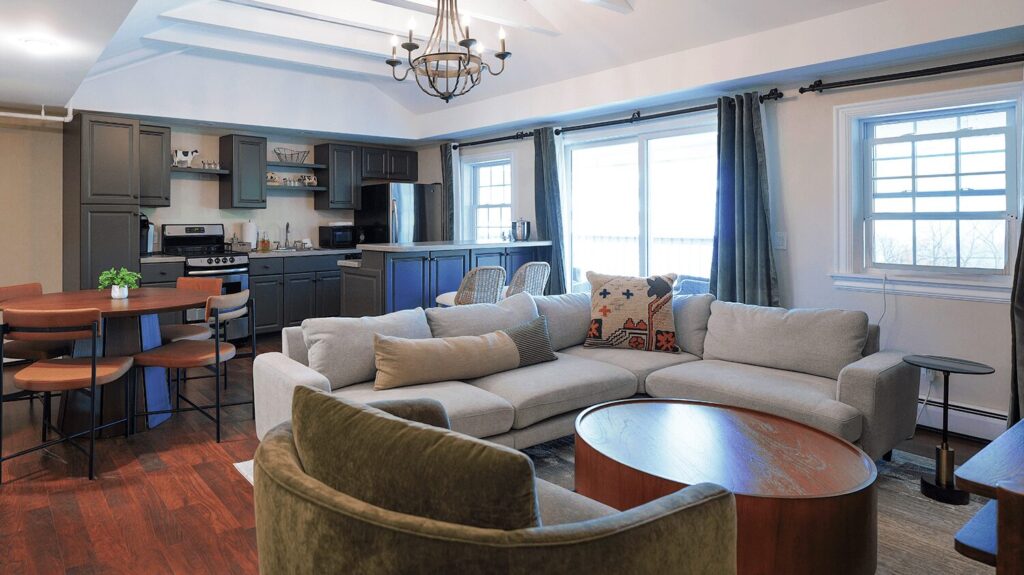Living room with kitchen and couch in Farmhouse room