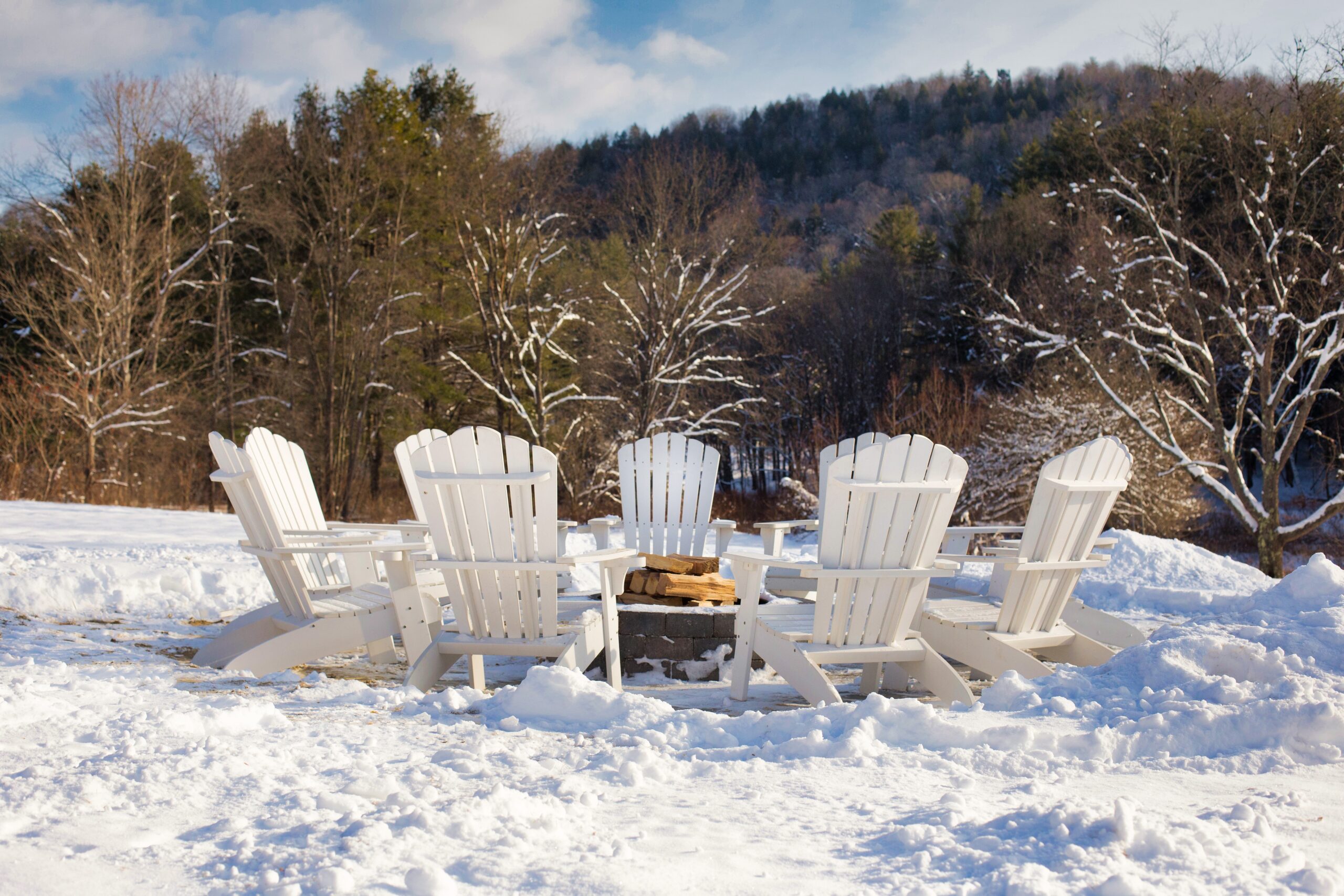 White chairs around firepit at On The River In n Vermont